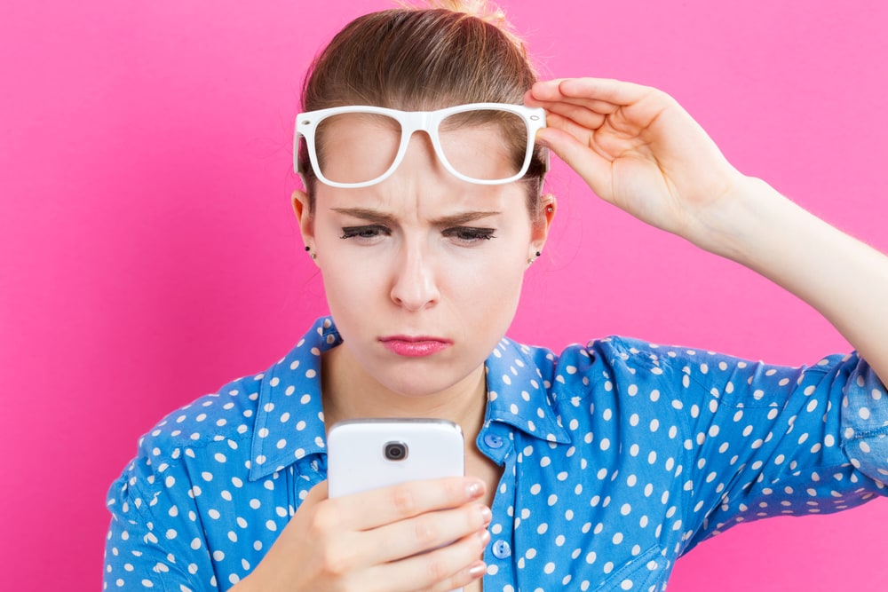 Woman staring at smartphone